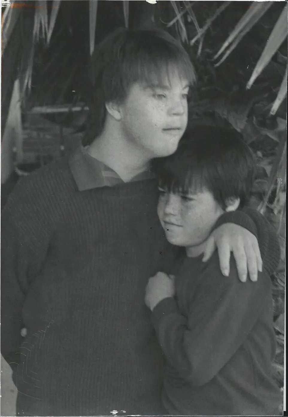 Two young boys share an affectionate embrace in a black and white photo, symbolizing the warmth and connection central to Linda Smith's advocacy for Down syndrome awareness and inspirational storytelling.| Linda’s Life – Linda Smith