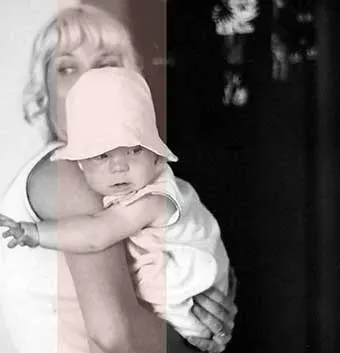 A woman holds a baby wearing a sun hat in a tender embrace. The image evokes themes of care and love, highlighting Linda Smith's advocacy for Down syndrome awareness and her role as a motivational speaker and disability advocate.| Linda’s Life – Linda Smith